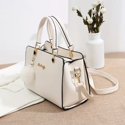 A Stylish Solid Color Handbag with Pom-Pom Decorations