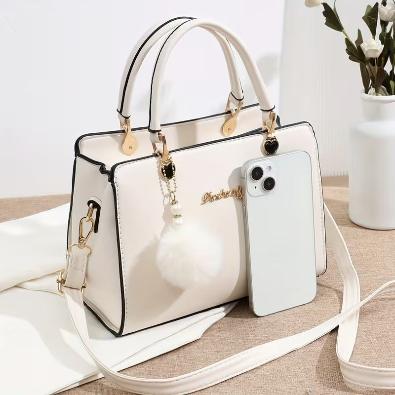 A Stylish Solid Color Handbag with Pom-Pom Decorations